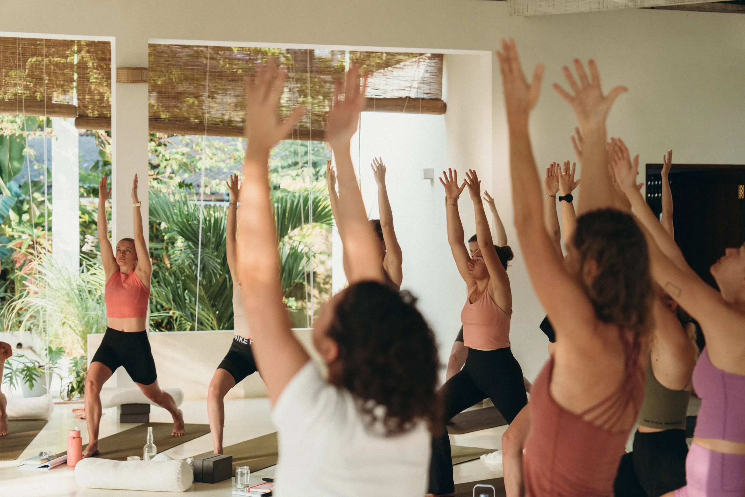 Yoga class in Sri Lanka with students in Warrior I pose at Lanka Yoga